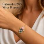 925 silver hamsa evil eye bracelet in gold plating worn on a woman's wrist